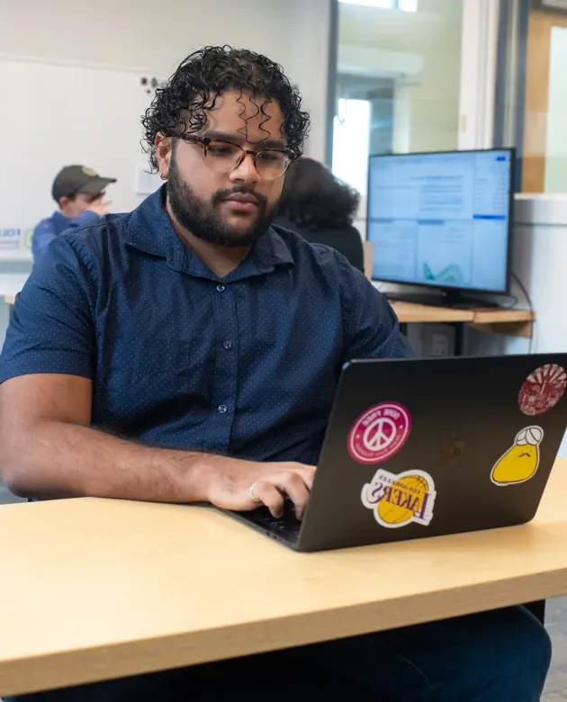 A students types on their laptop